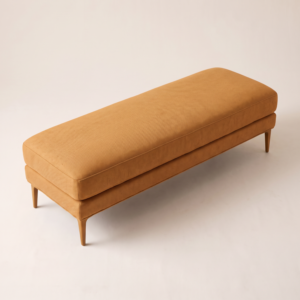 Amber Muse ottoman bench, elevated three-quarter view showing the cushion top