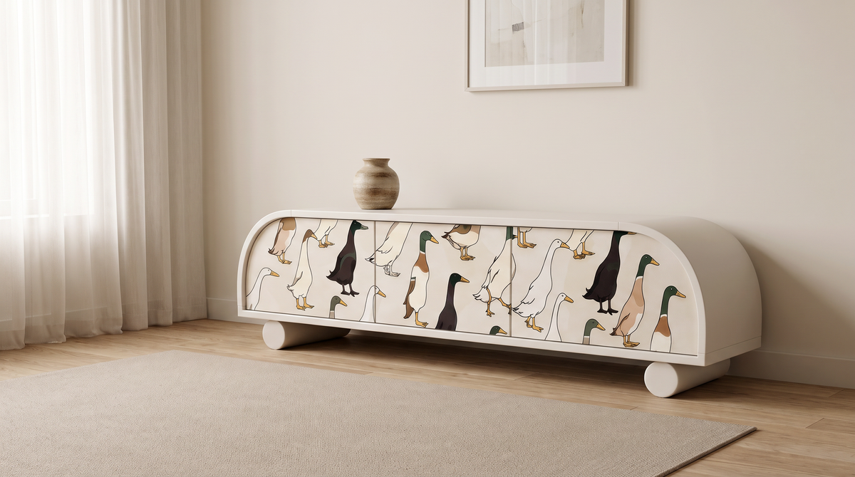 Arcade storage console with illustrated wallpaper doors styled in a calm living room