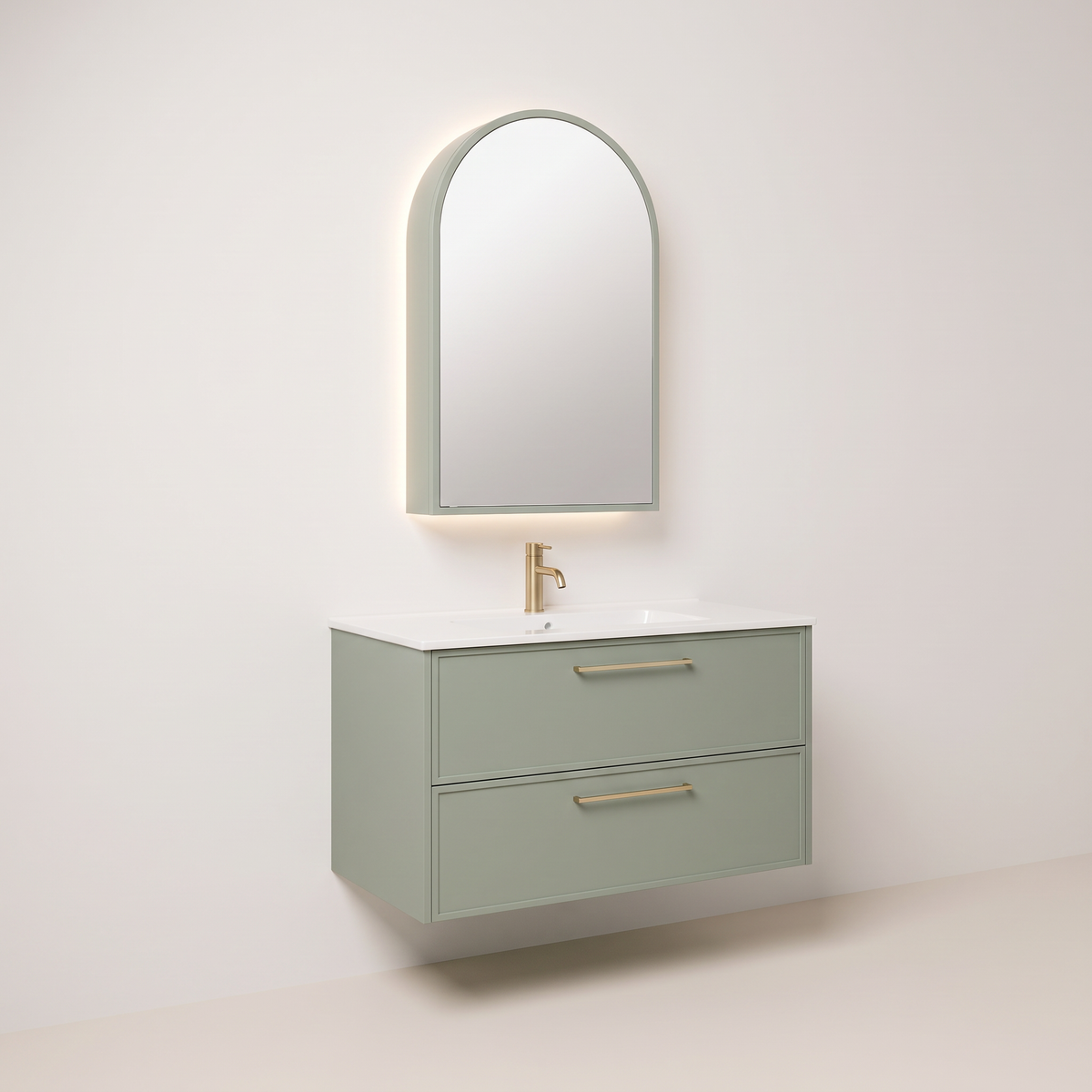 Arch Mirror Vanity in sage green with brass pulls and arched mirror cabinet, front-left three-quarter view