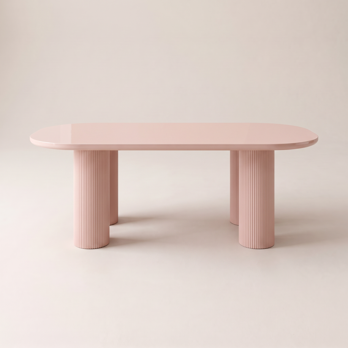 Aurelia dining table with blush-pink gloss racetrack top on four fluted column legs, front elevation