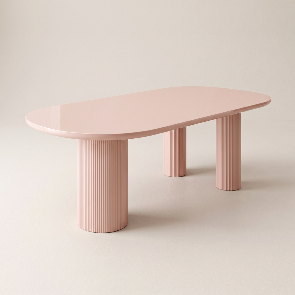 Aurelia dining table with blush-pink gloss racetrack top on four fluted column legs, front three-quarter view