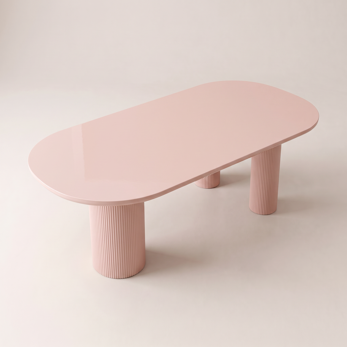 Aurelia dining table with blush-pink gloss racetrack top on four fluted column legs, elevated top view