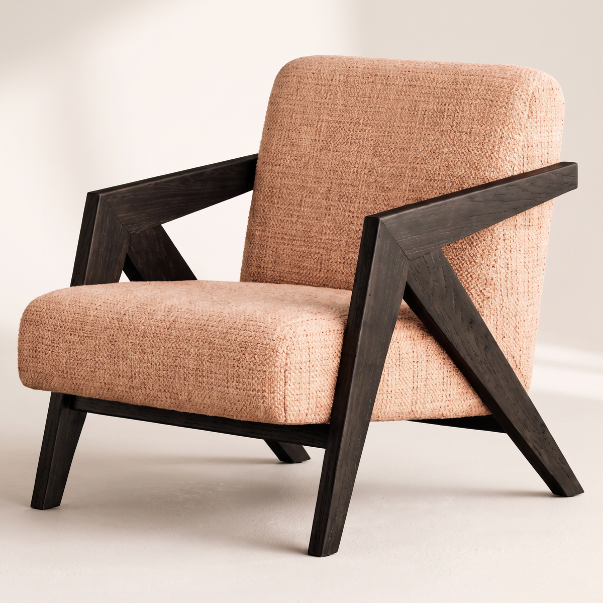 Axis Sand lounge chair in sand peach textured tweed with angular black wooden frame, front three-quarter view