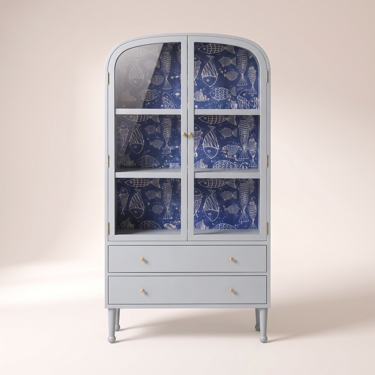 Azure Cove Cabinet in powder blue with glass doors, navy fish-print wallpaper, two drawers and brass knobs, front view