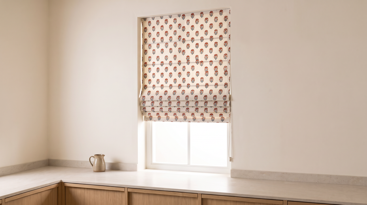 Bagh Roman Blind styled on a window above a counter in a calm kitchen