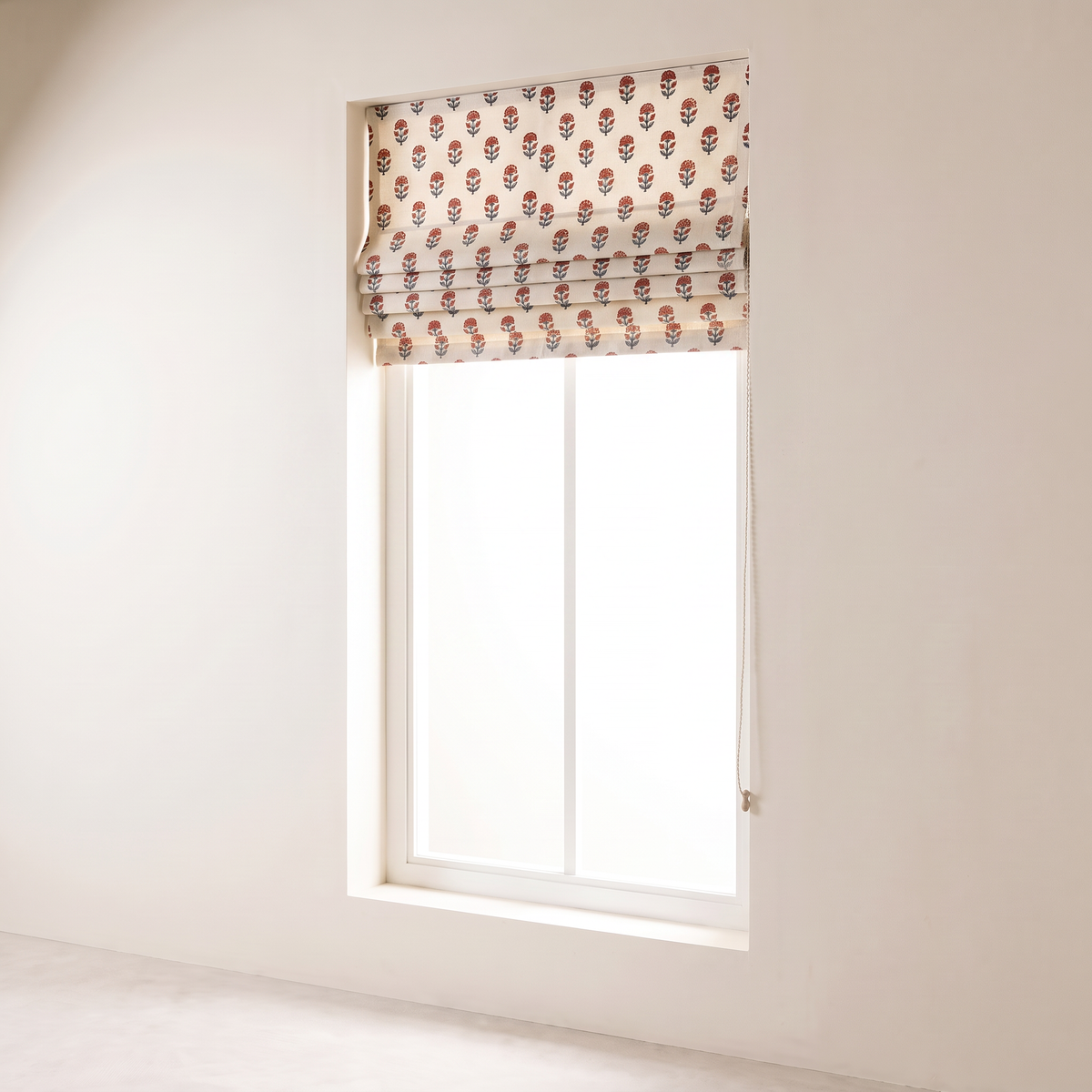Bagh Roman Blind fully raised into a neat stack of printed folds at the top of the window