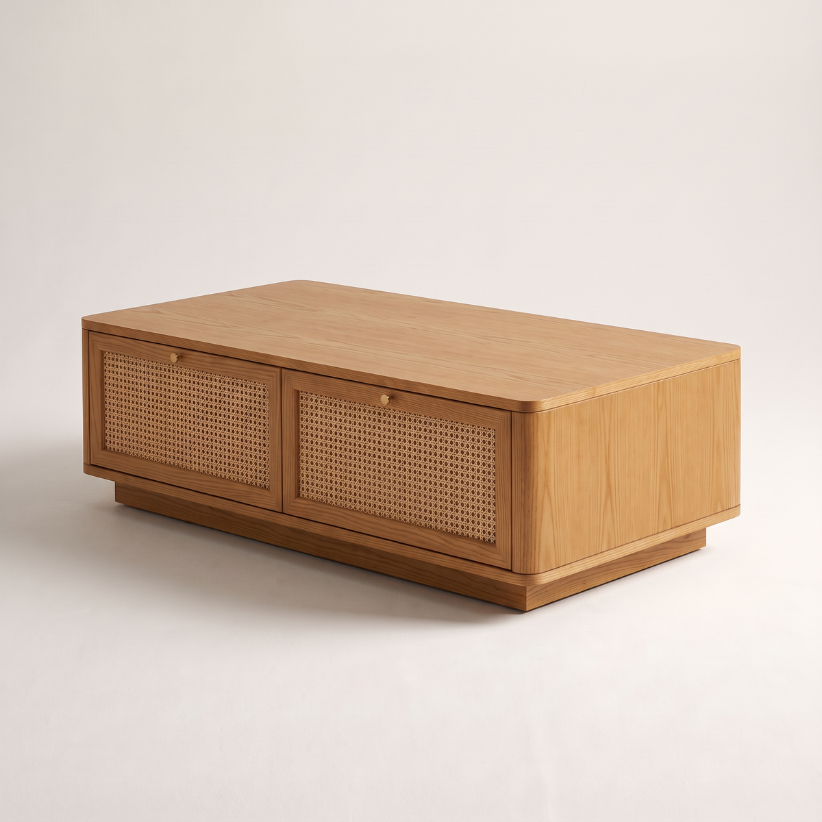 Bento Ash coffee table in honey ash with rounded corners and cane drawers, front-right three-quarter view
