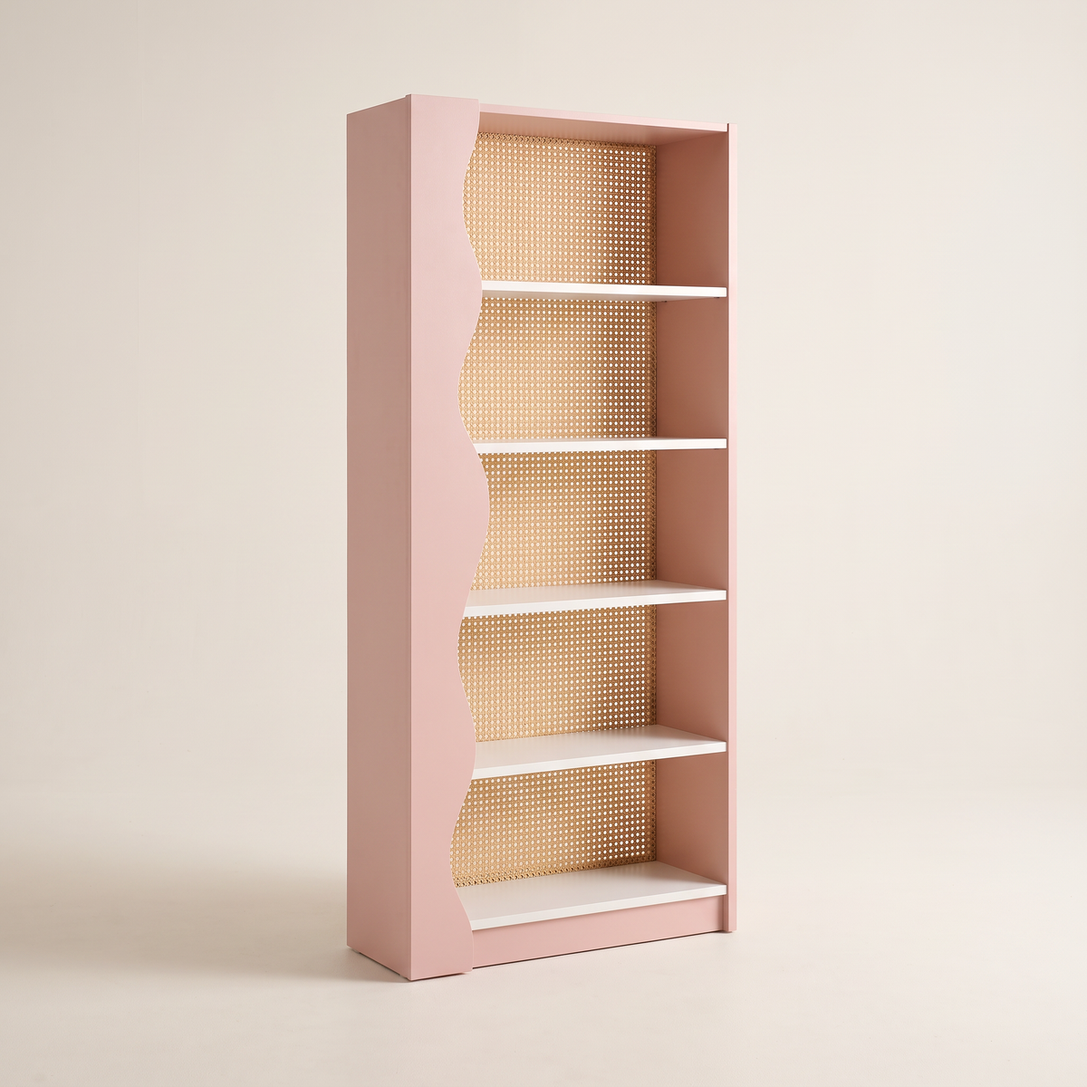 Blush Cane bookcase in blush pink with wavy side and woven cane back, front three-quarter view