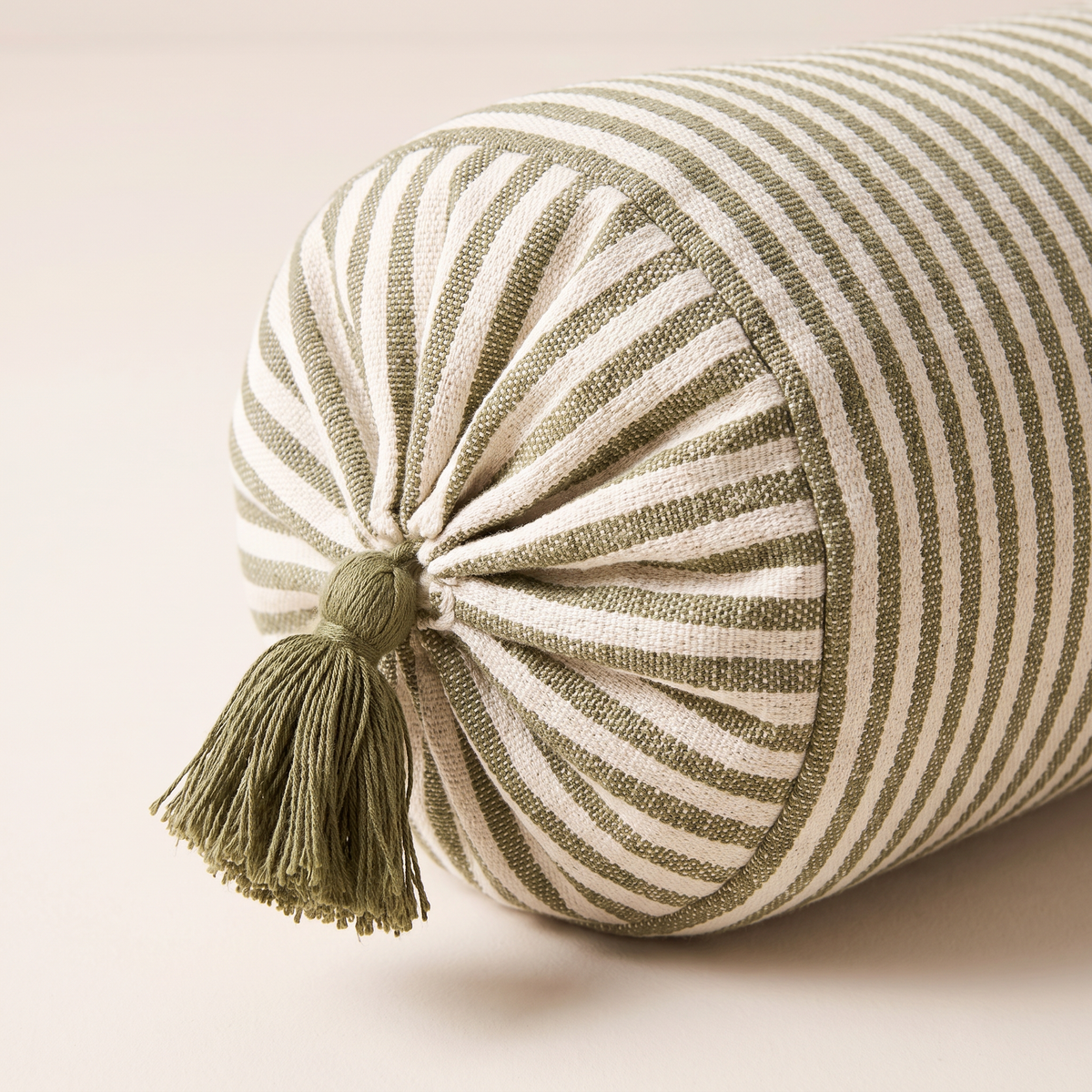 Close-up of Bolster Stripe gathered end with olive tassel and handwoven stripes