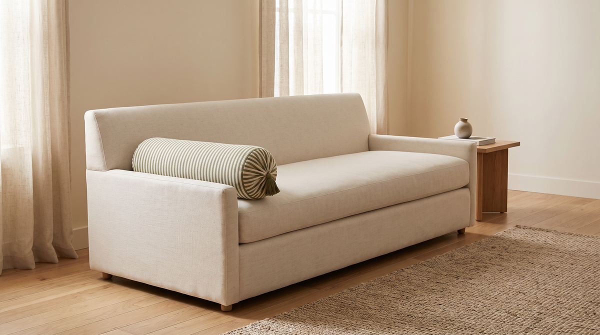 Bolster Stripe styled against the arm of an ivory sofa in a calm living room