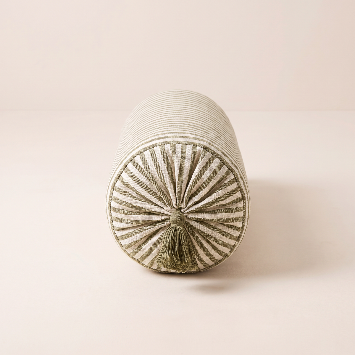 Bolster Stripe end view showing the gathered end and olive tassel