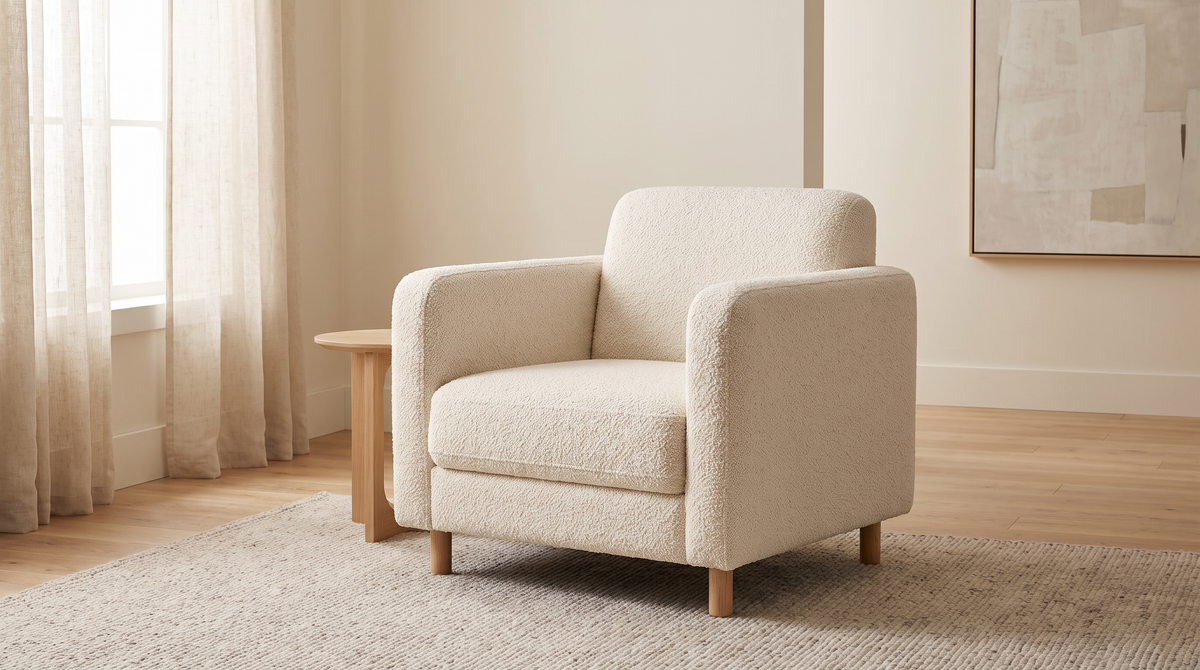 Bouclé Ivory fabric shown as the upholstery of a simple armchair in a calm living room