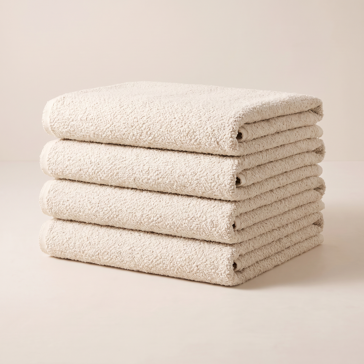 Bouclé Ivory upholstery fabric, neatly folded stack in warm ivory