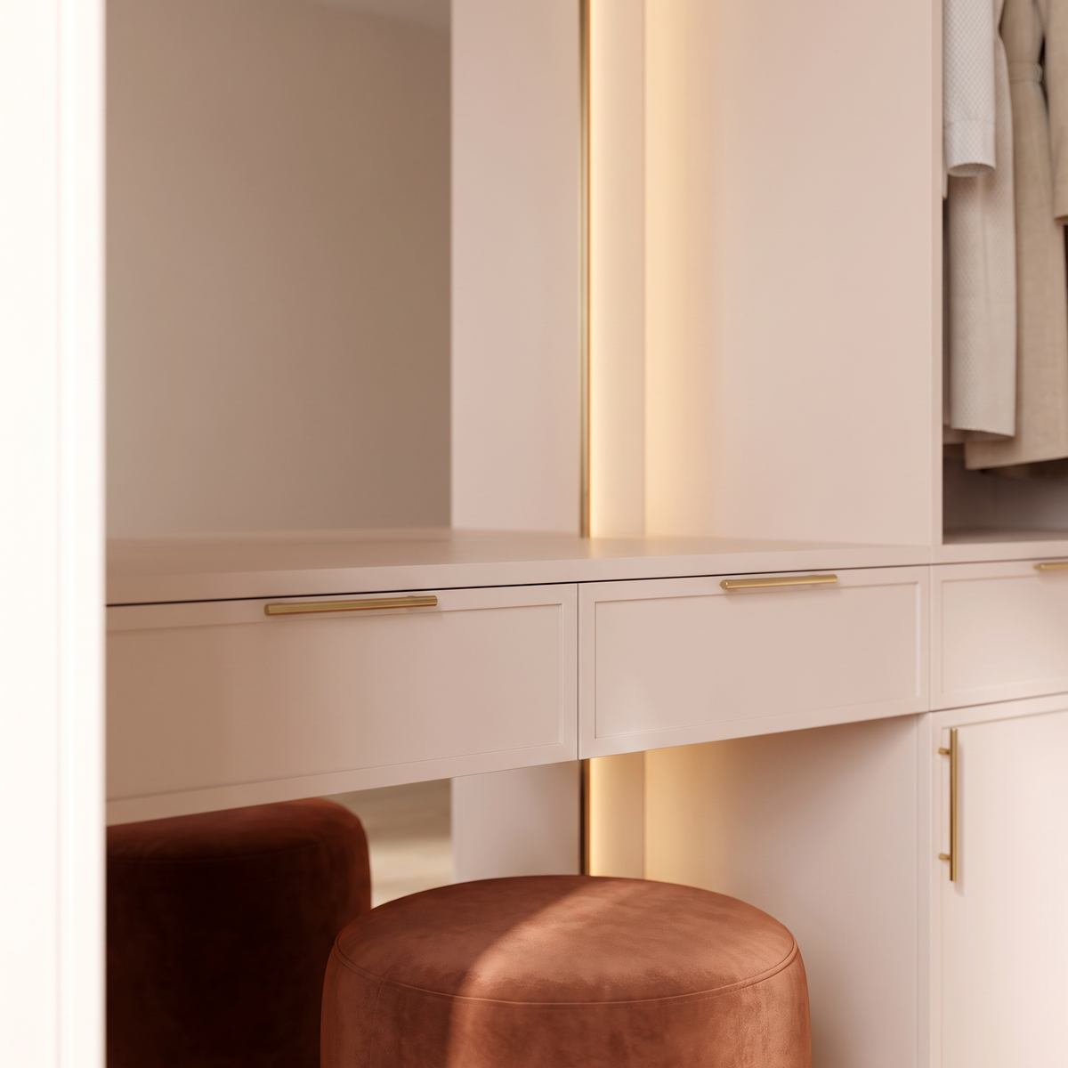 Boudoir Closet detail: blush-ivory counter drawers with thin brass handles, warm LED mirror edge and rust velvet pouf