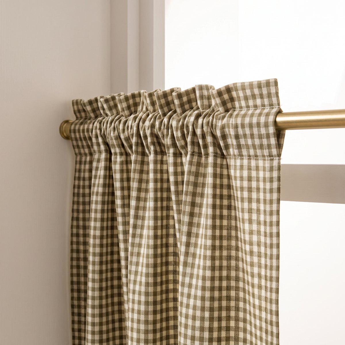 Close-up of Café Gingham rod-pocket heading gathered on a brass rod in small olive and ivory checks