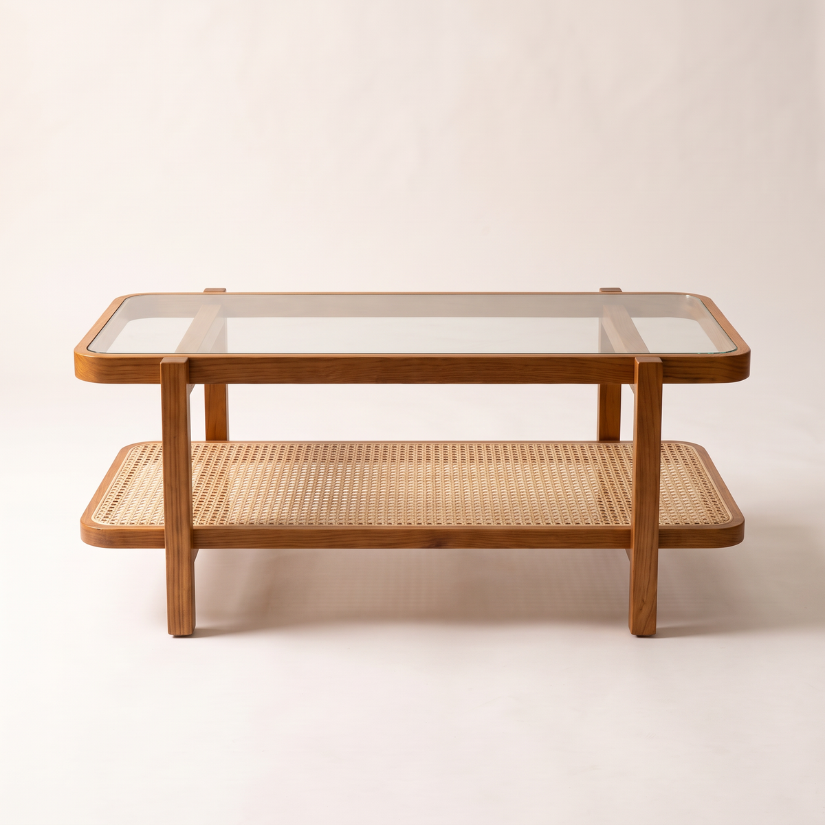 Canehaven coffee table in honey ash wood with clear glass top and woven cane shelf, front elevation