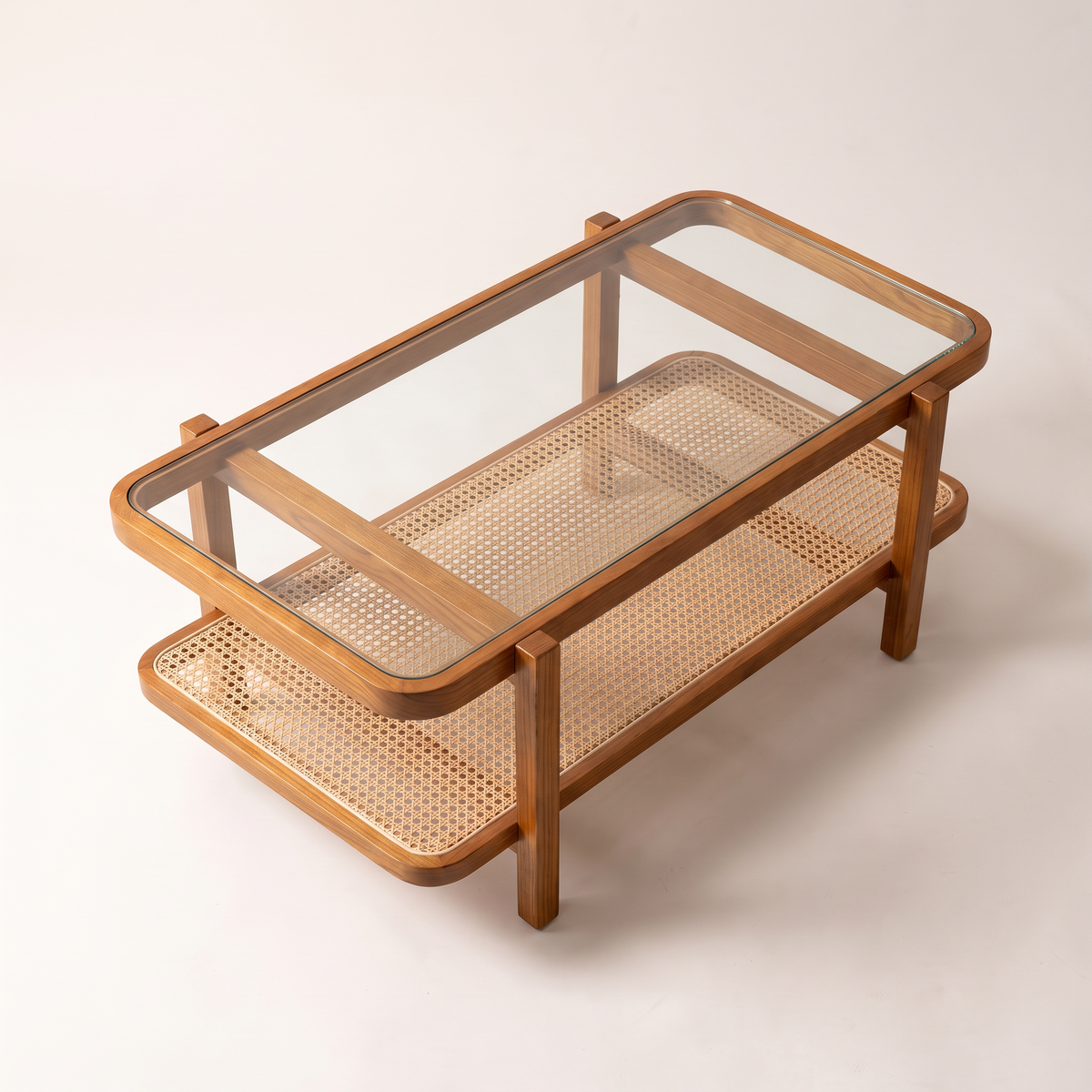 Canehaven coffee table in honey ash wood with clear glass top and woven cane shelf, elevated top view