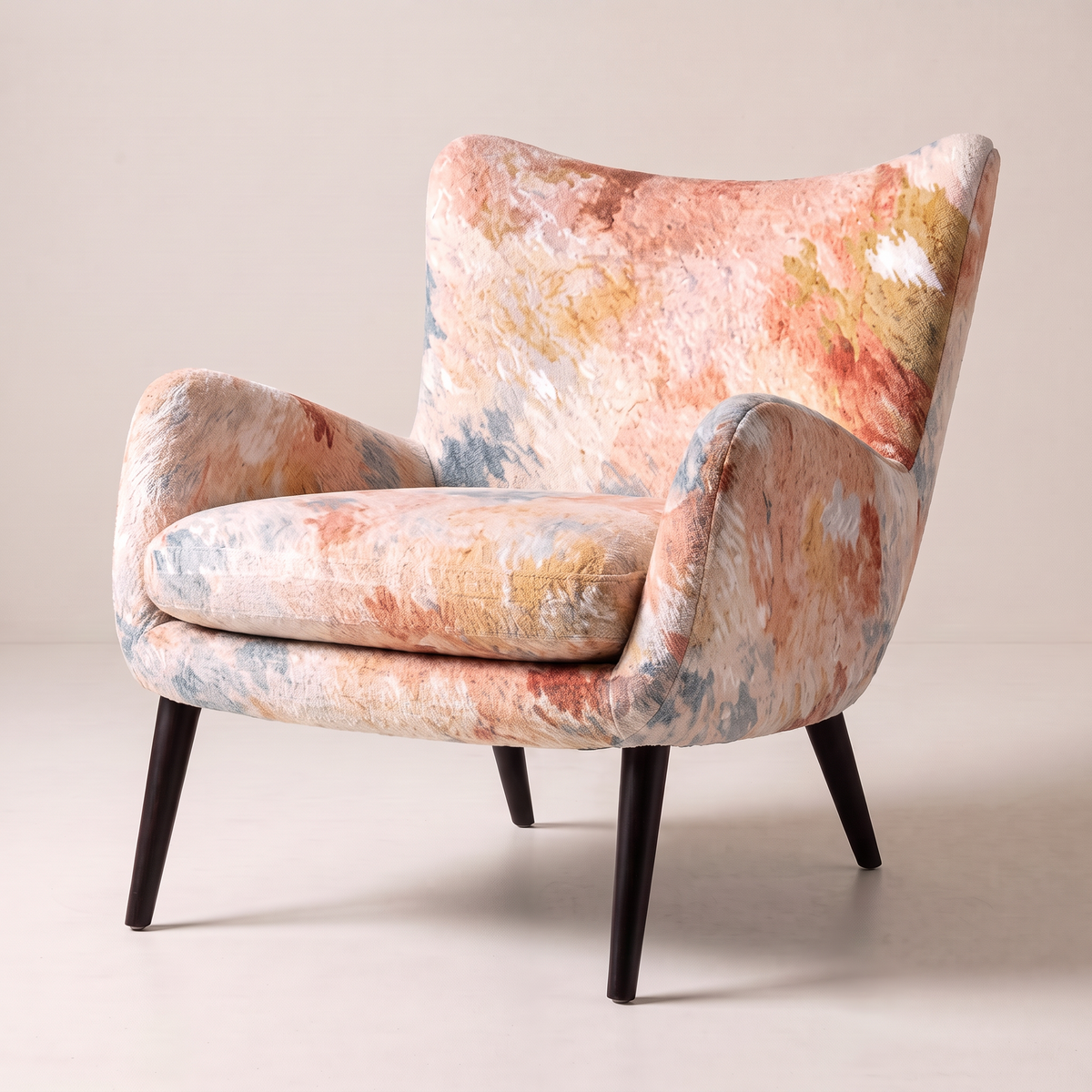 Canvas Fresco wingback lounge chair in painterly watercolour print with black tapered legs, opposite three-quarter view