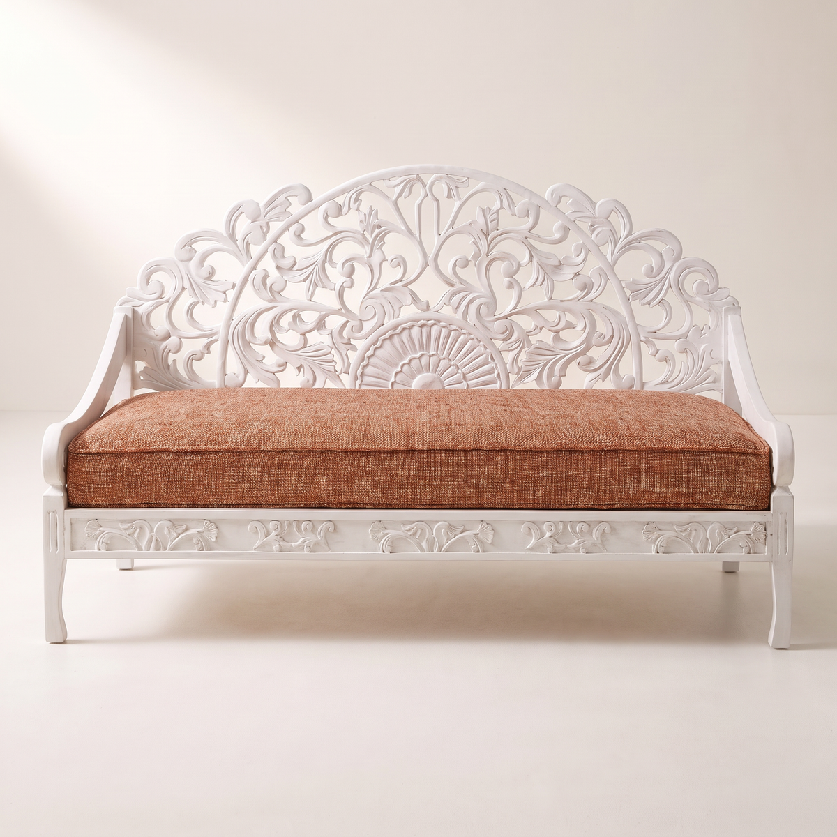 Carve White hand-carved white wooden sofa with openwork arched back and rust tweed seat cushion, front view