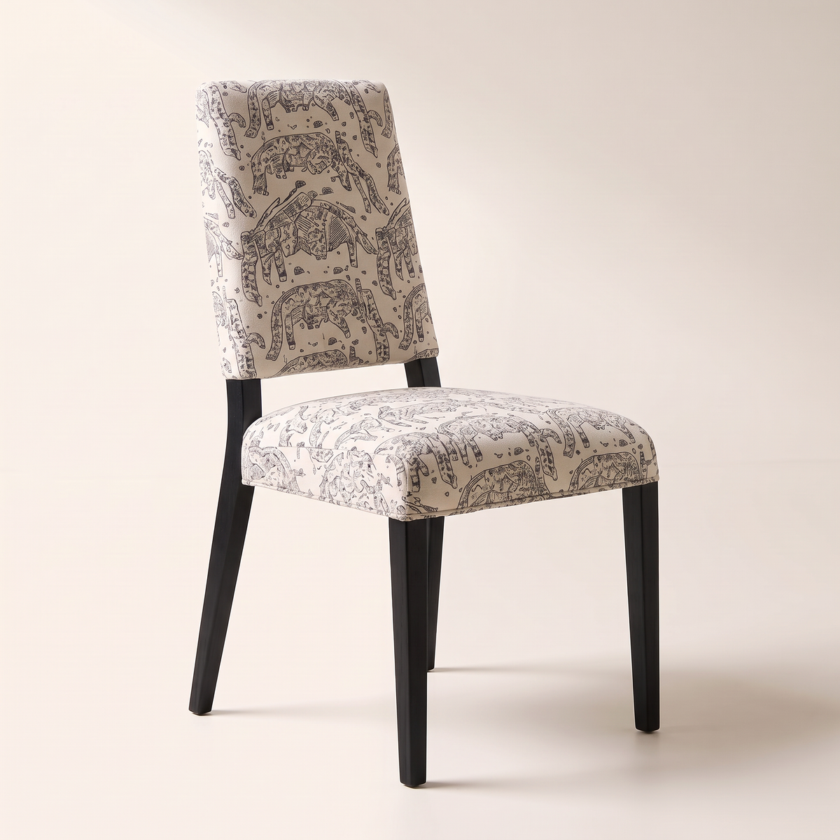 Chair 401 dining chair in cream elephant-print upholstery with black wooden legs, front-right three-quarter view