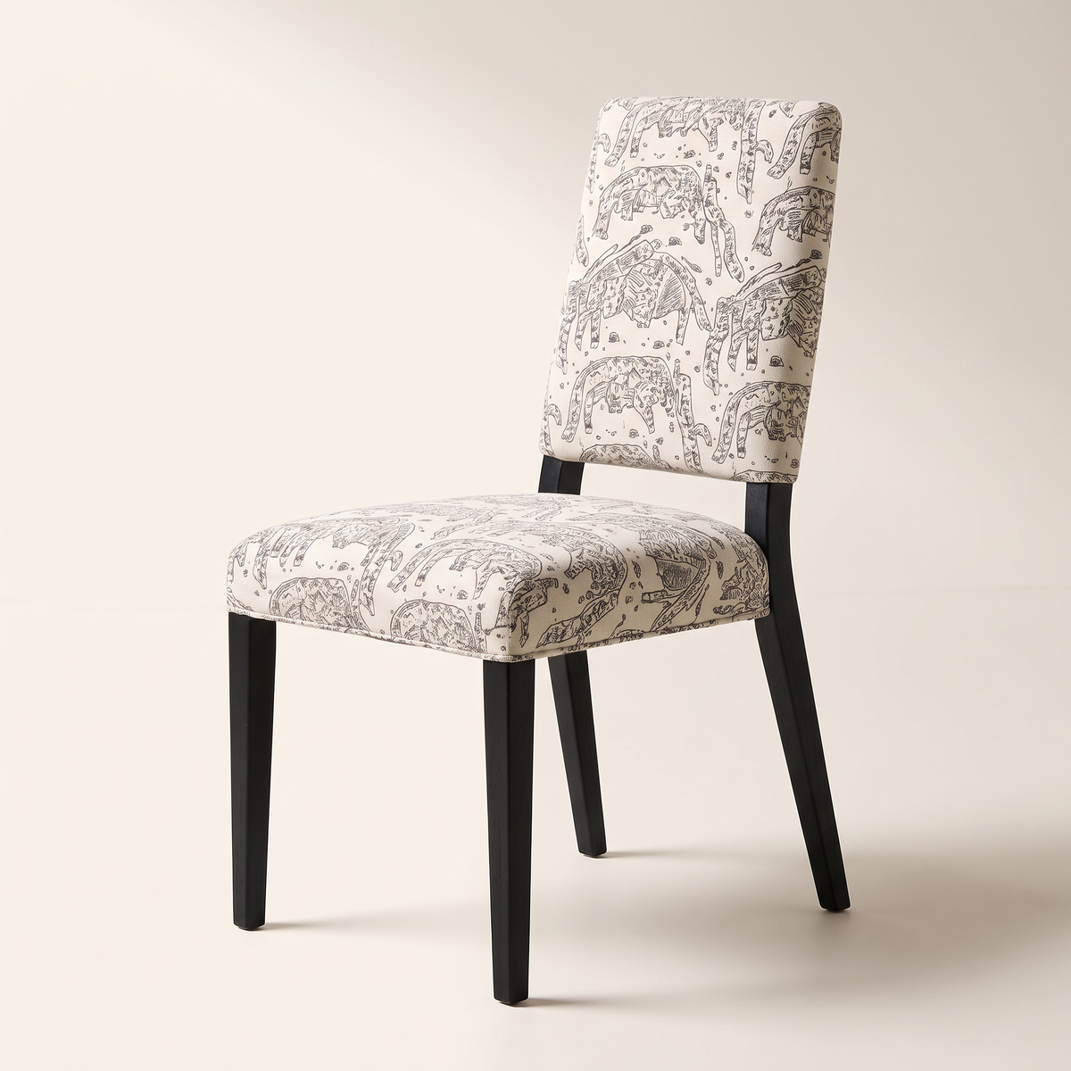 Chair 401 dining chair in cream elephant-print upholstery with black wooden legs, front three-quarter view