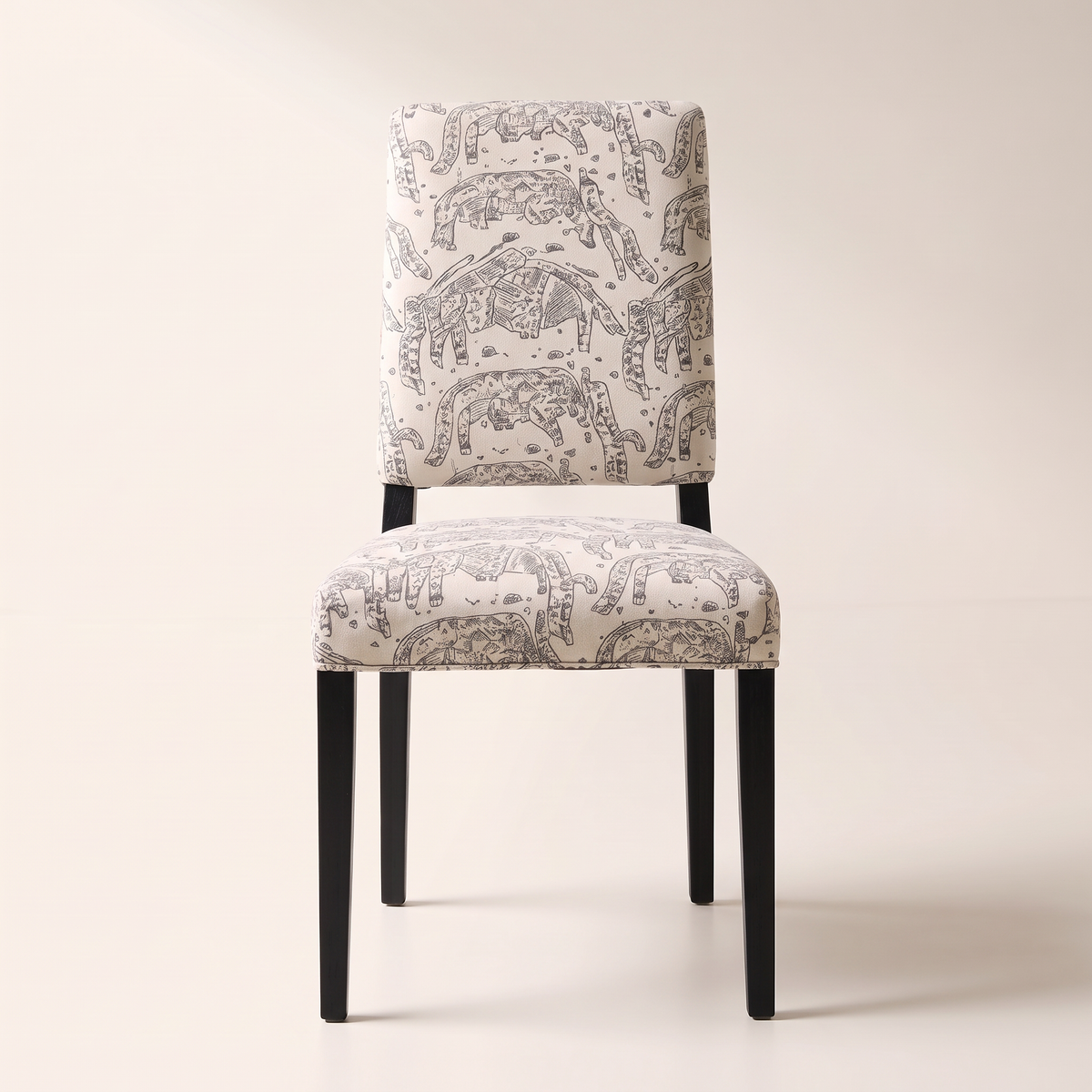 Chair 401 dining chair in cream elephant-print upholstery with black wooden legs, front view