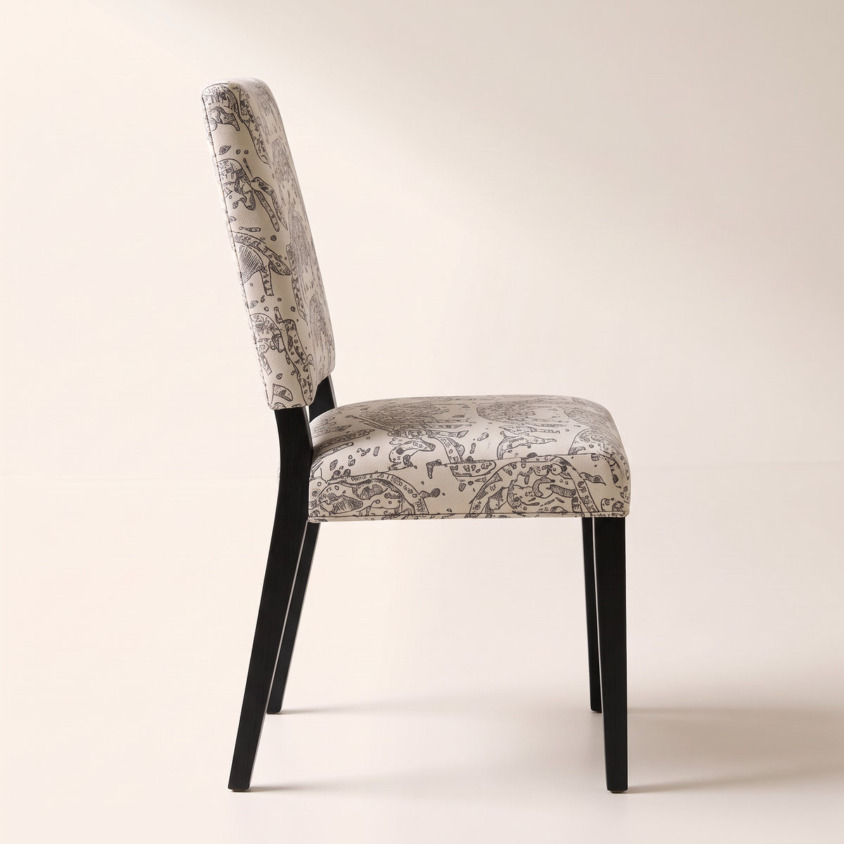 Chair 401 dining chair in cream elephant-print upholstery with black wooden legs, side profile