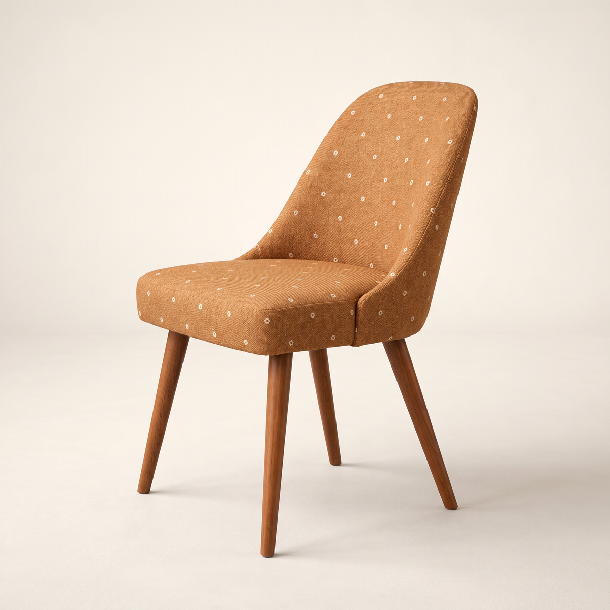 Chair 402 dining chair in caramel dotted upholstery with tapered wooden legs, front three-quarter view