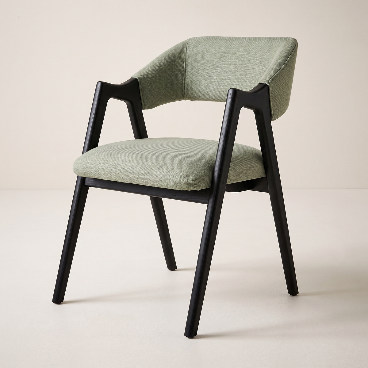 Chair 403 dining armchair in sage green upholstery with black wooden A-frame, front three-quarter view