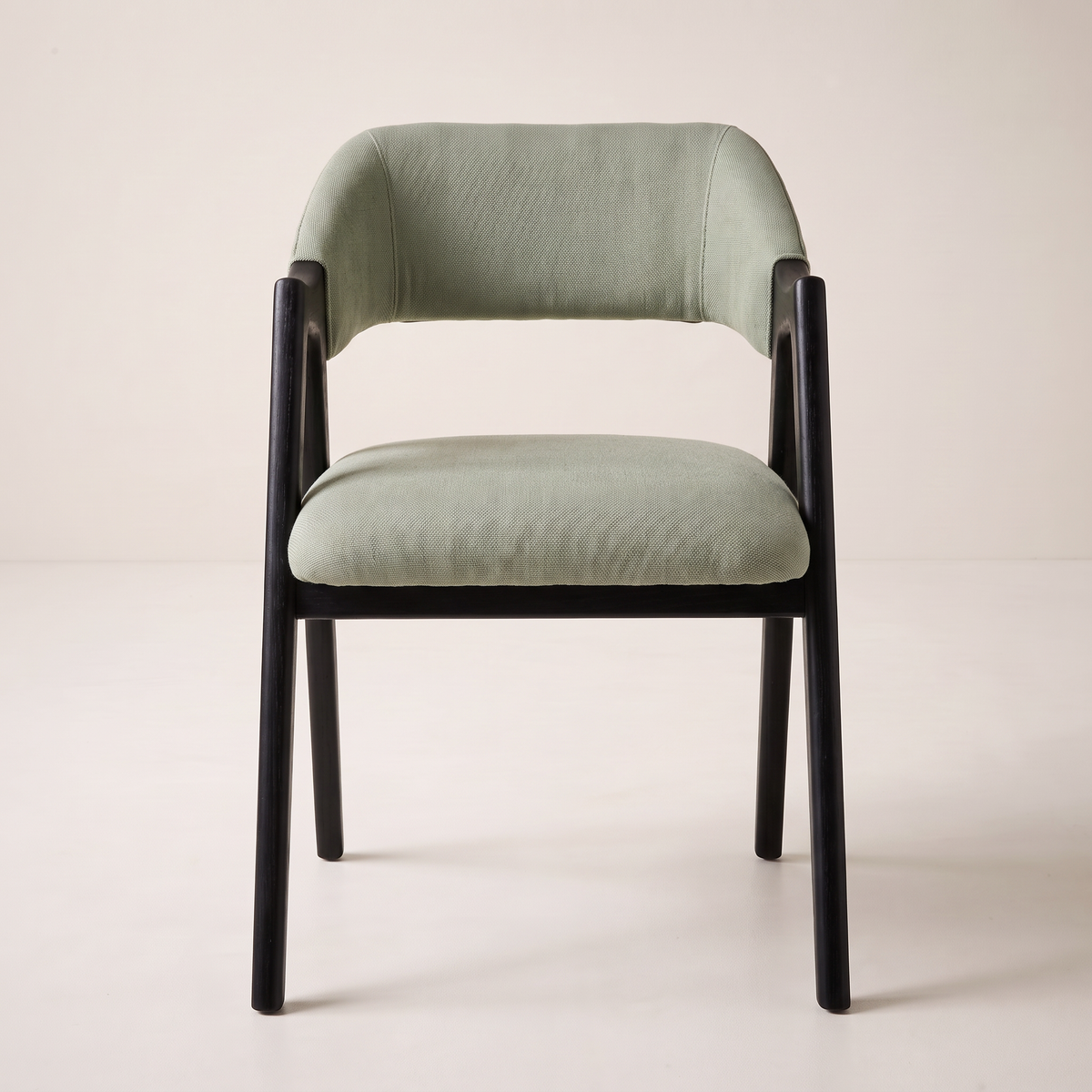 Chair 403 dining armchair in sage green upholstery with black wooden A-frame, front view