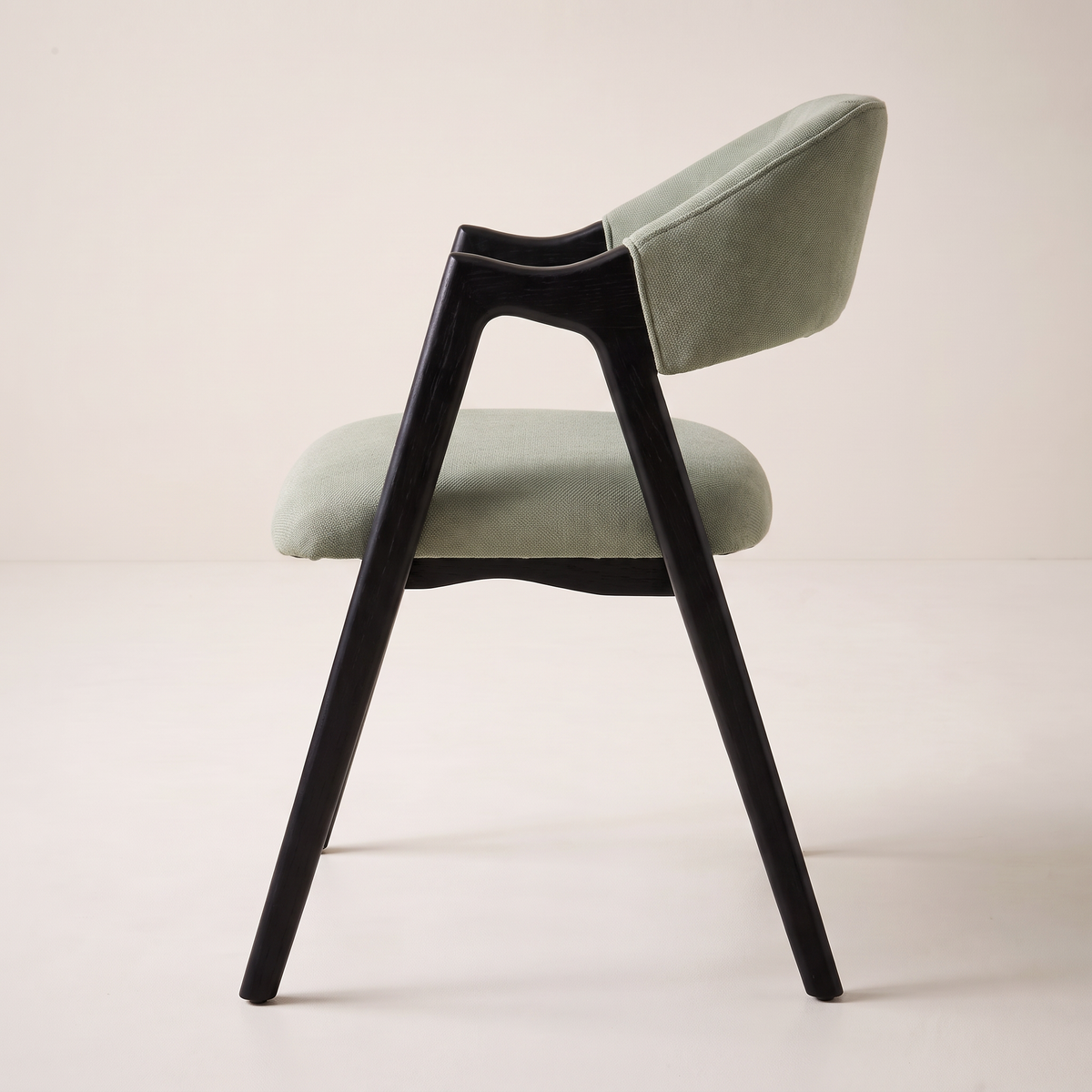 Chair 403 dining armchair in sage green upholstery with black wooden A-frame, side profile