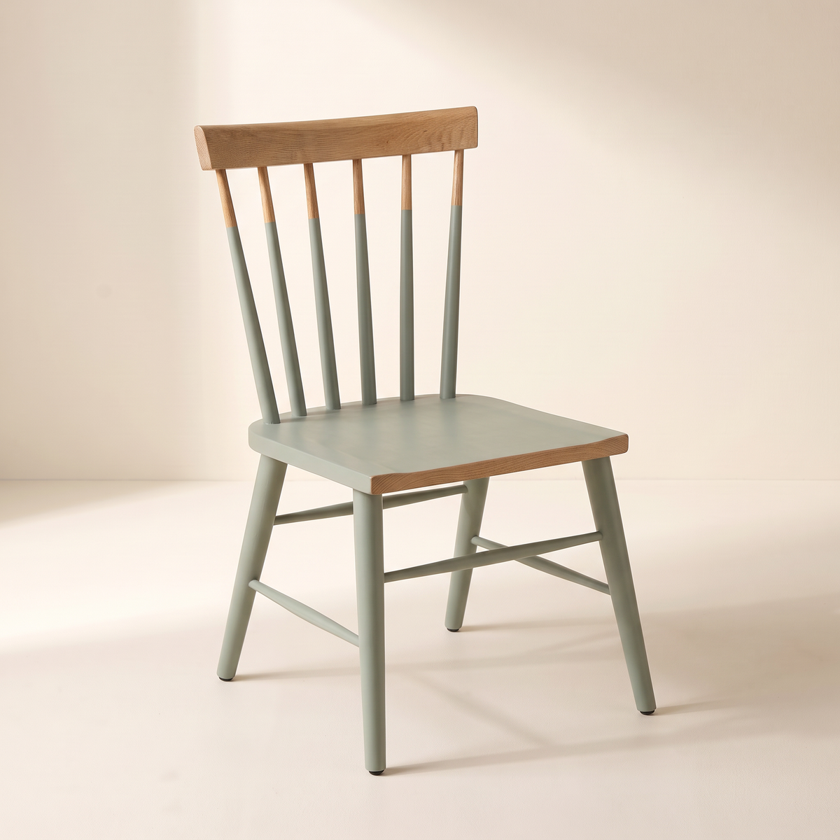 Chair 508 sage green spindle-back dining chair with natural wood crest rail, front-right three-quarter view
