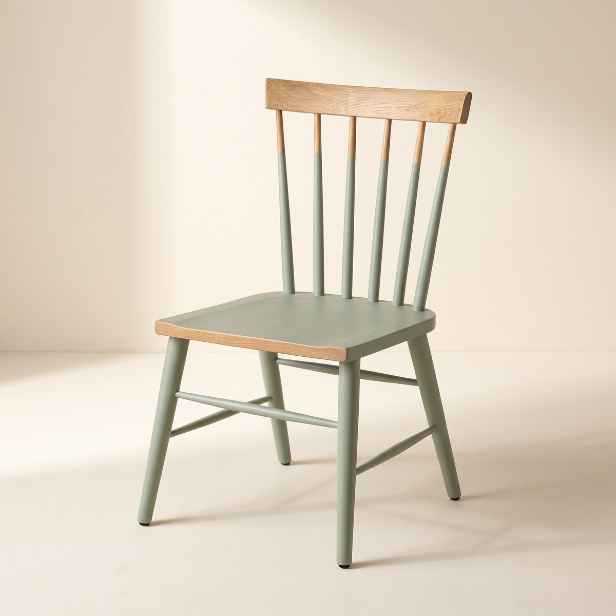 Chair 508 sage green spindle-back dining chair with natural wood crest rail, front three-quarter view