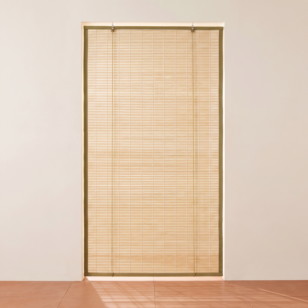 Chik Bamboo Blind fully lowered with light filtering through the split bamboo, straight front view