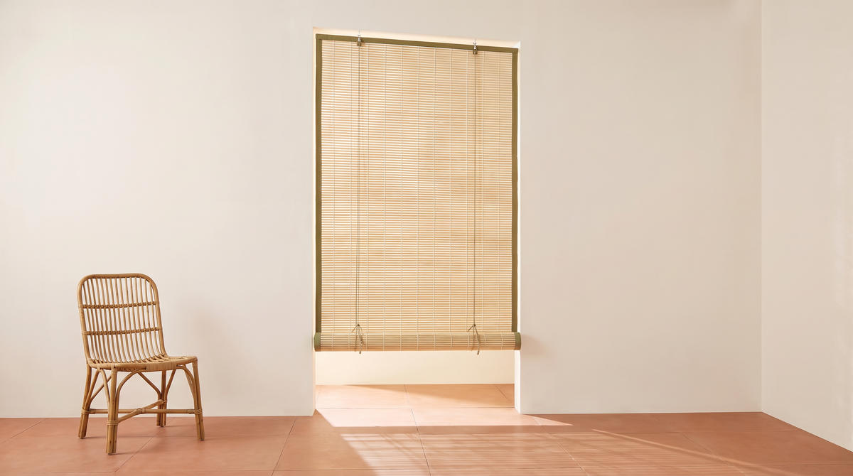 Chik Bamboo Blind styled in a verandah opening with dappled light on a terracotta floor