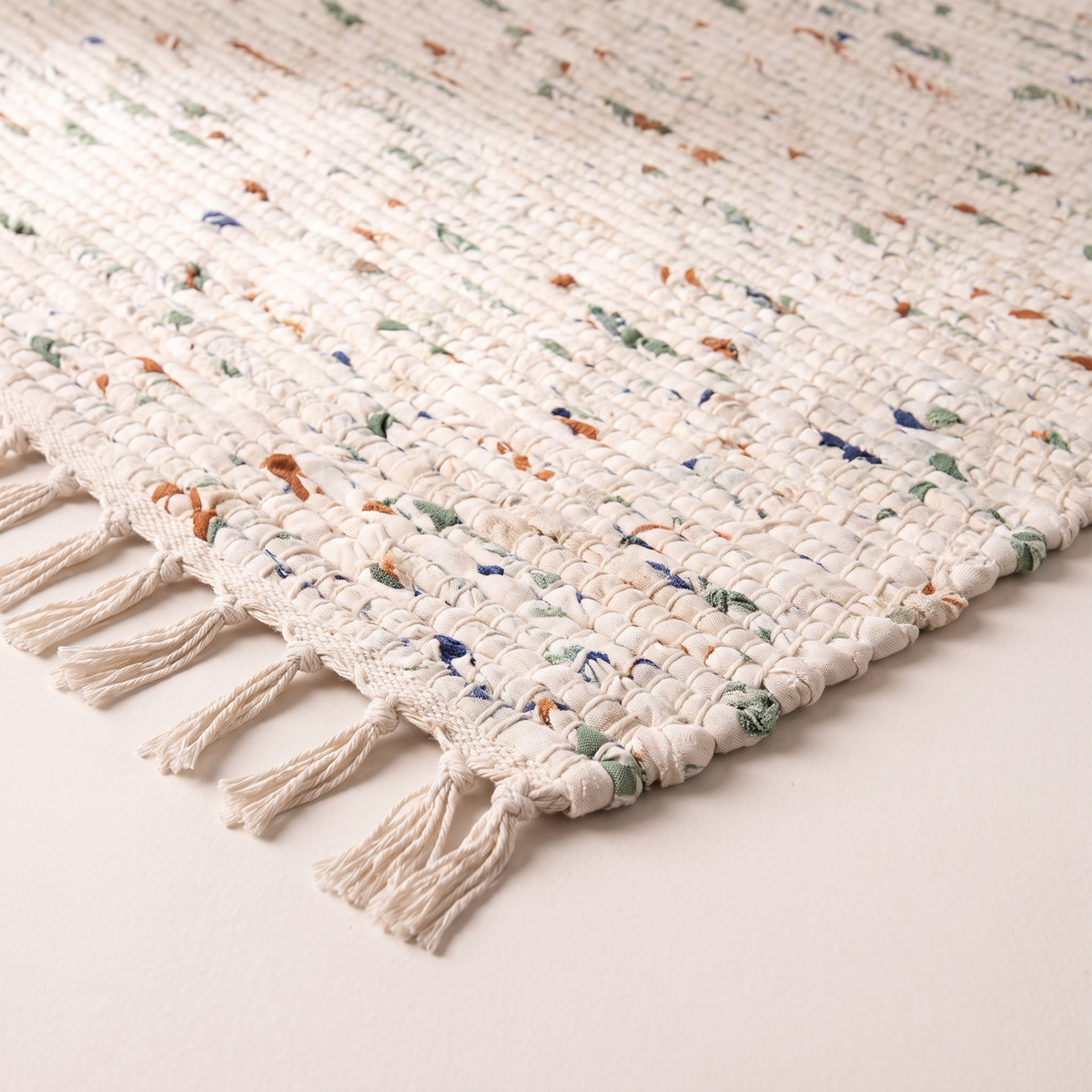 Chindi Rag Rug corner close-up showing twisted cotton fabric strips and knotted fringe
