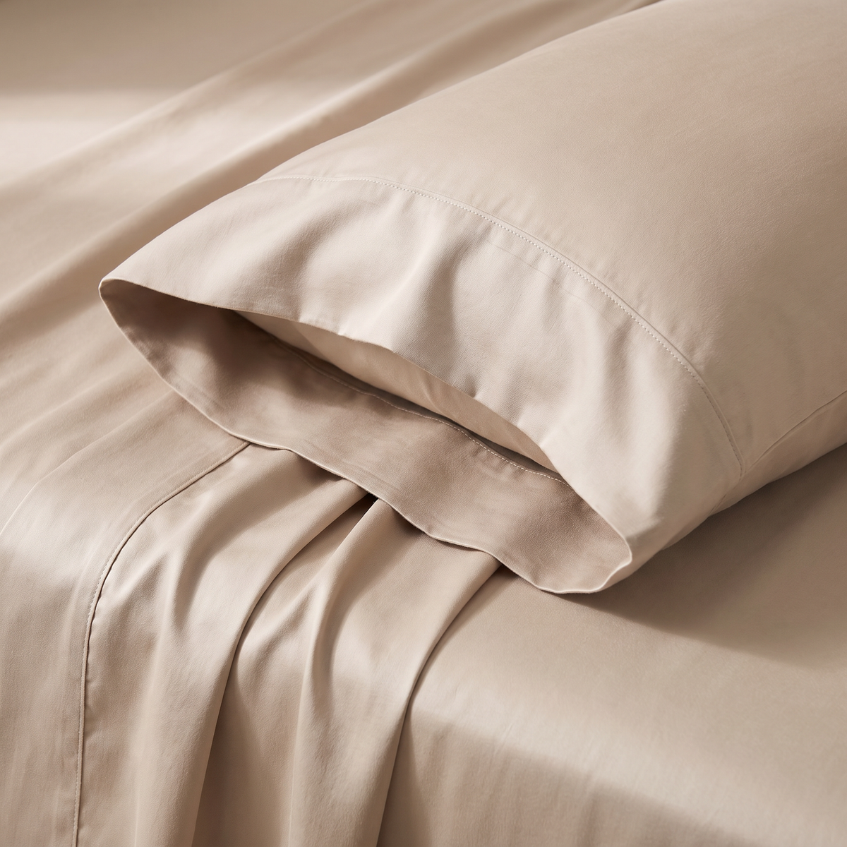 Close-up of Cool Tencel pillow cover hem and sheet folds showing the smooth sheen