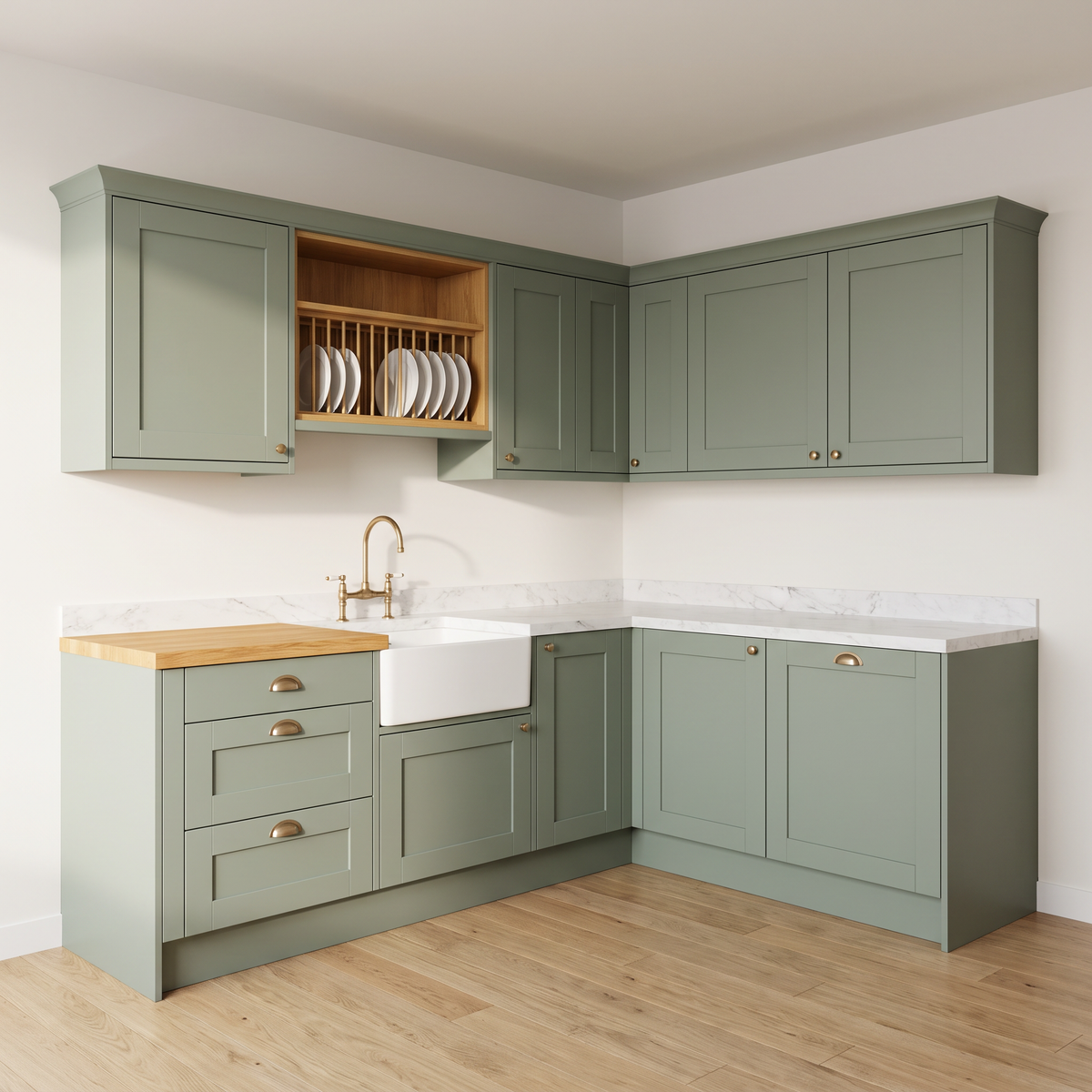 Cottage Shaker L-shaped kitchen with sage matte Shaker doors, brass cup pulls, ash plate rack, butcher block and white farmhouse sink, front three-quarter view