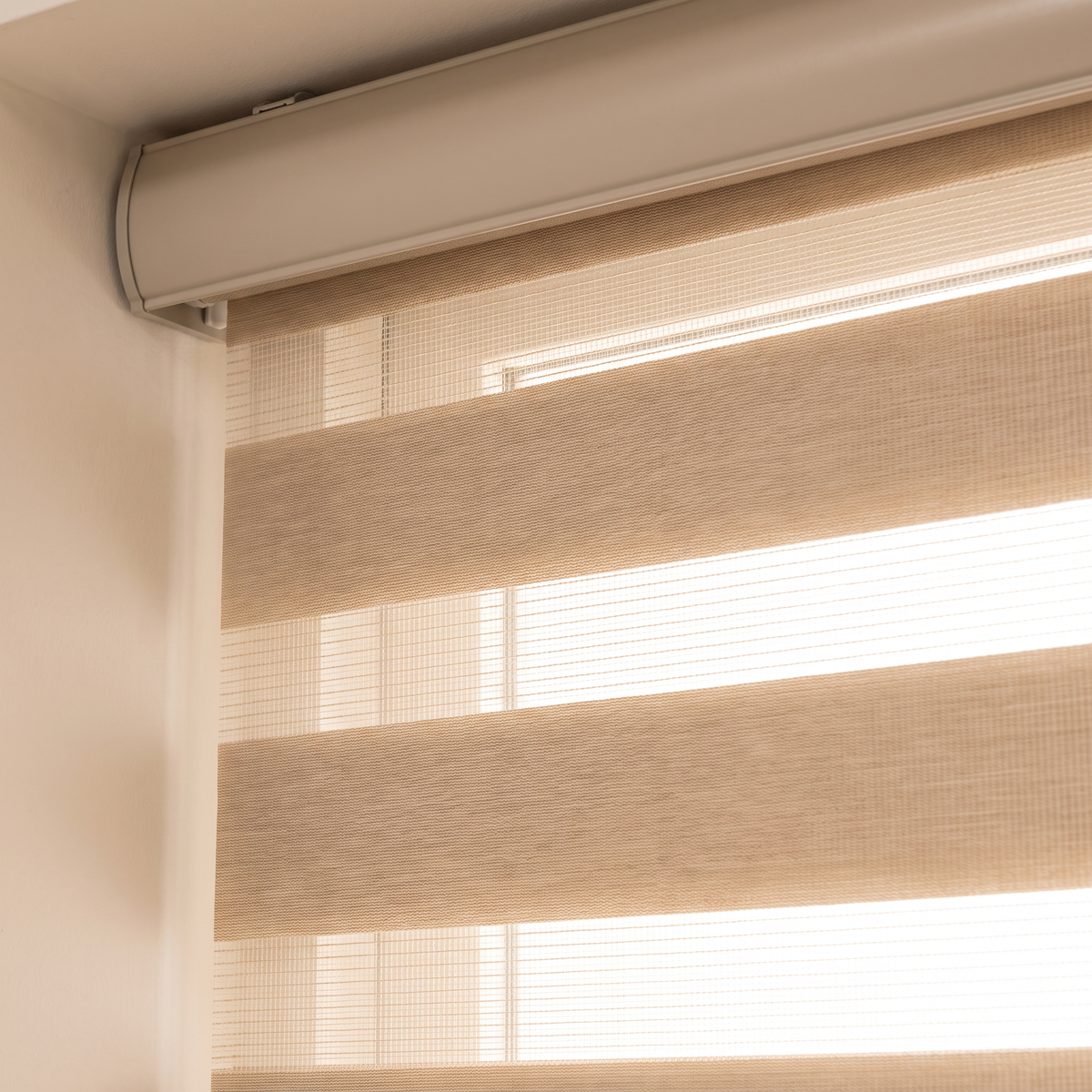 Close-up of Duo Day-Night blind cassette and alternating sheer and solid sand-beige bands