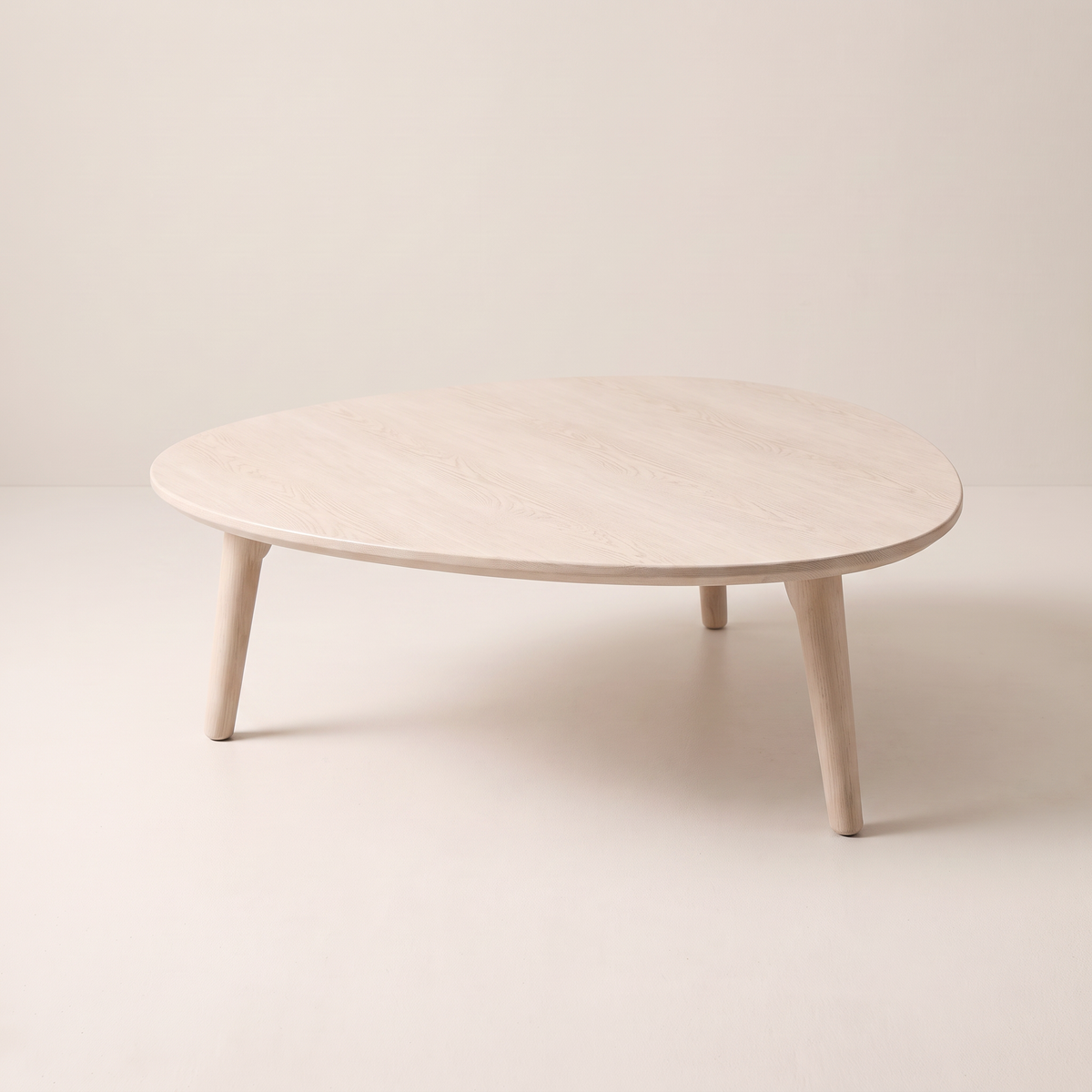 Eira Ash coffee table with pebble-shaped pale wood top, front-right view