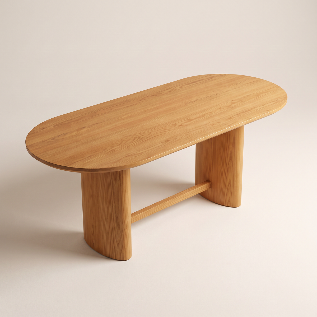 Ember Oval dining table showing its racetrack-oval solid ash top, elevated three-quarter view