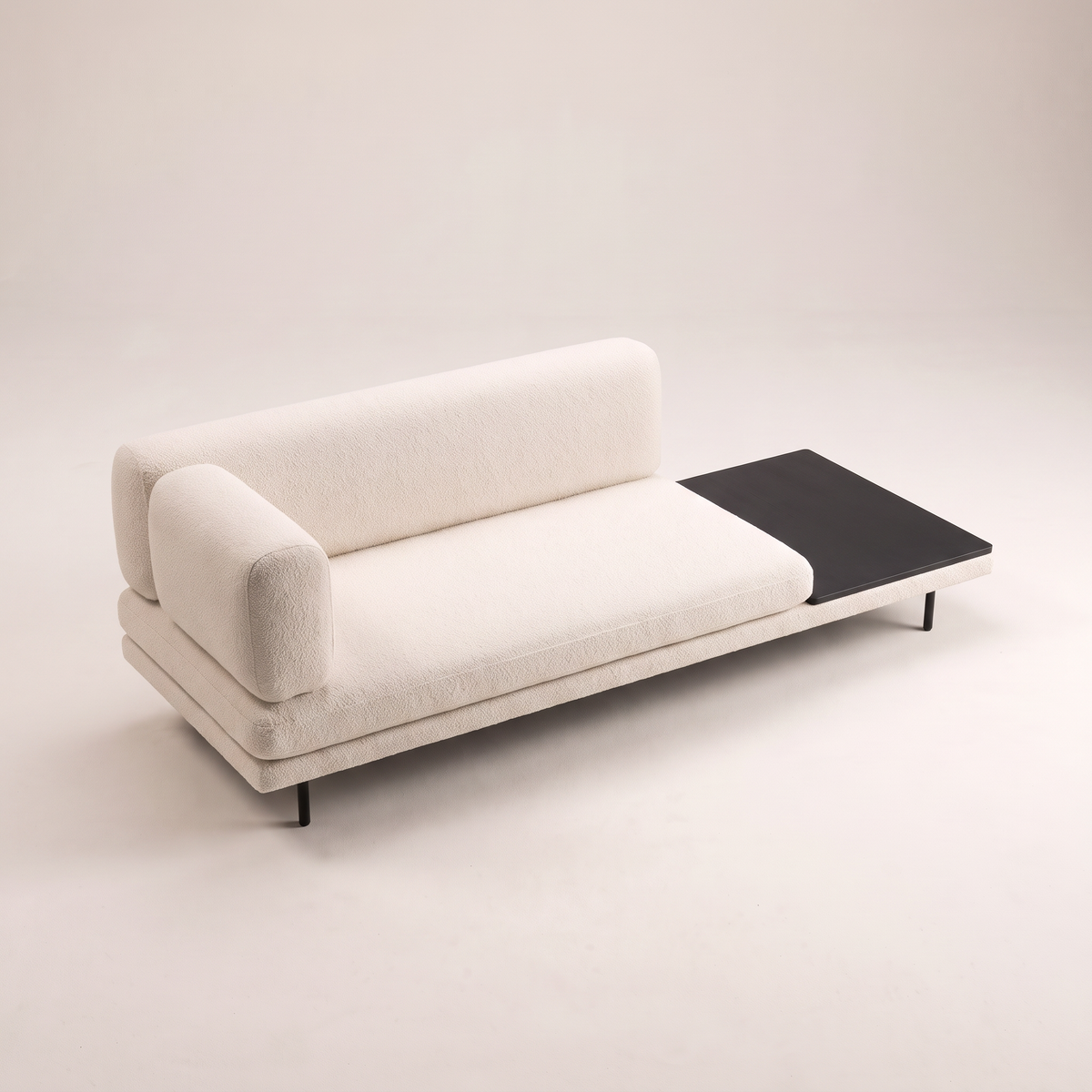 Eon Ivory low sofa in ivory boucle-style upholstery with dark table panel, elevated three-quarter view
