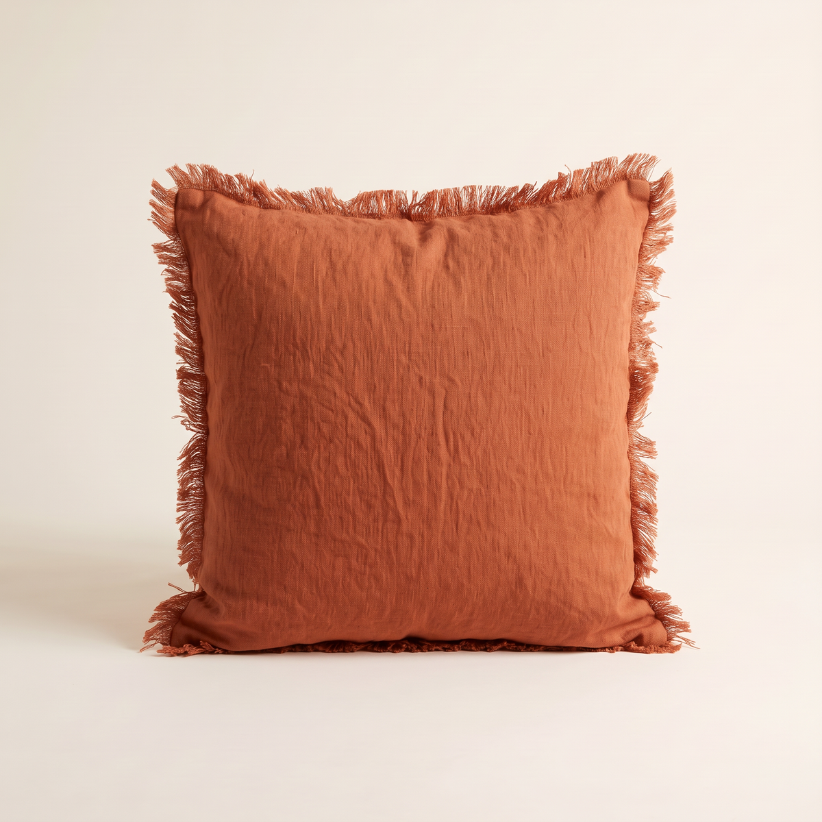 Fringe Linen Cushion in washed rust linen, straight front view