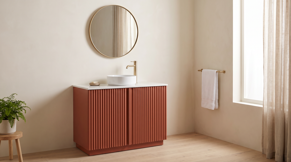 Furrow Rust Vanity with round brass mirror styled in a calm bathroom