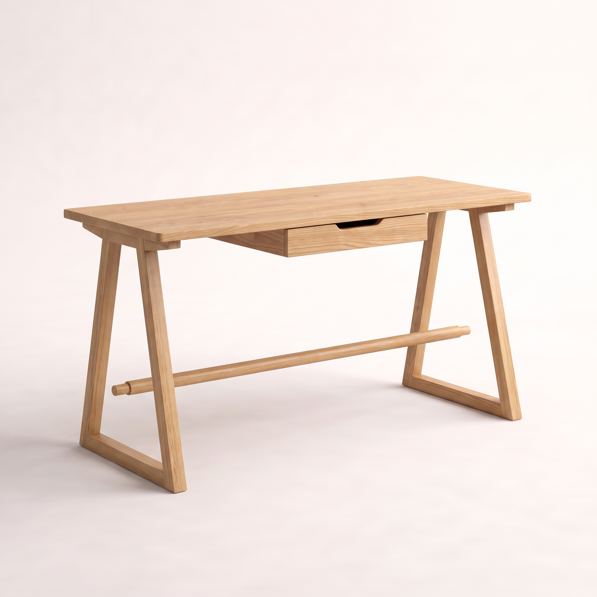 Gable Trestle solid ash desk with A-frame trestle legs, through-tenoned stretcher and centre drawer, front three-quarter view