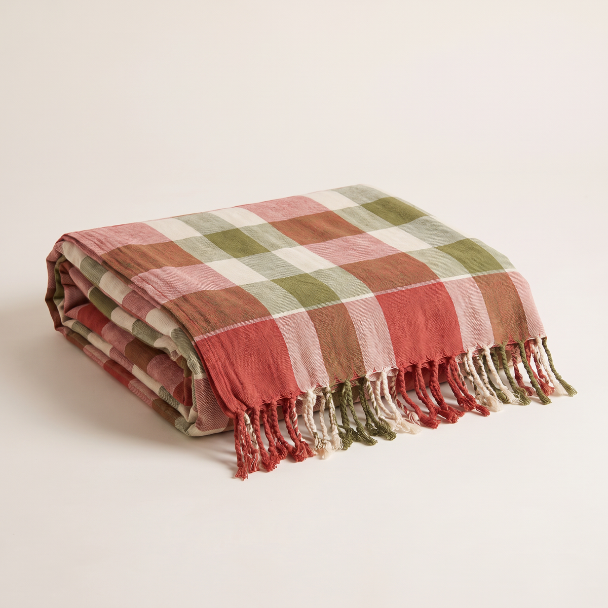 Gamcha Check Throw in red, ivory and olive handloom check, folded with fringe showing