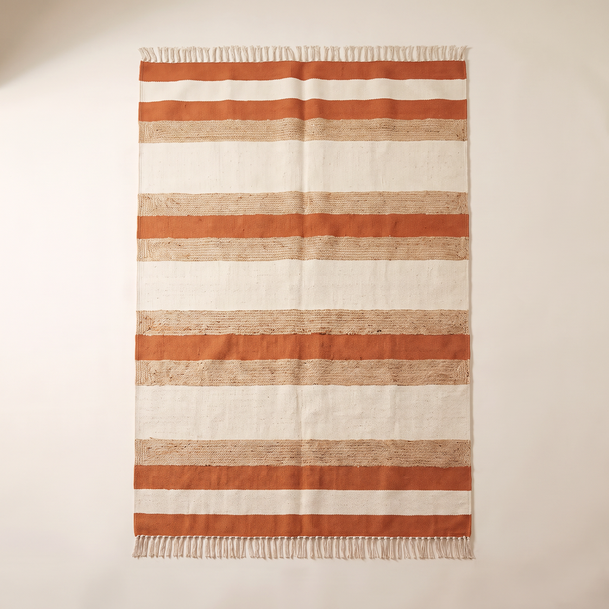 Ganga Stripe Dhurrie in ivory, oat jute and rust stripes, overhead flat lay