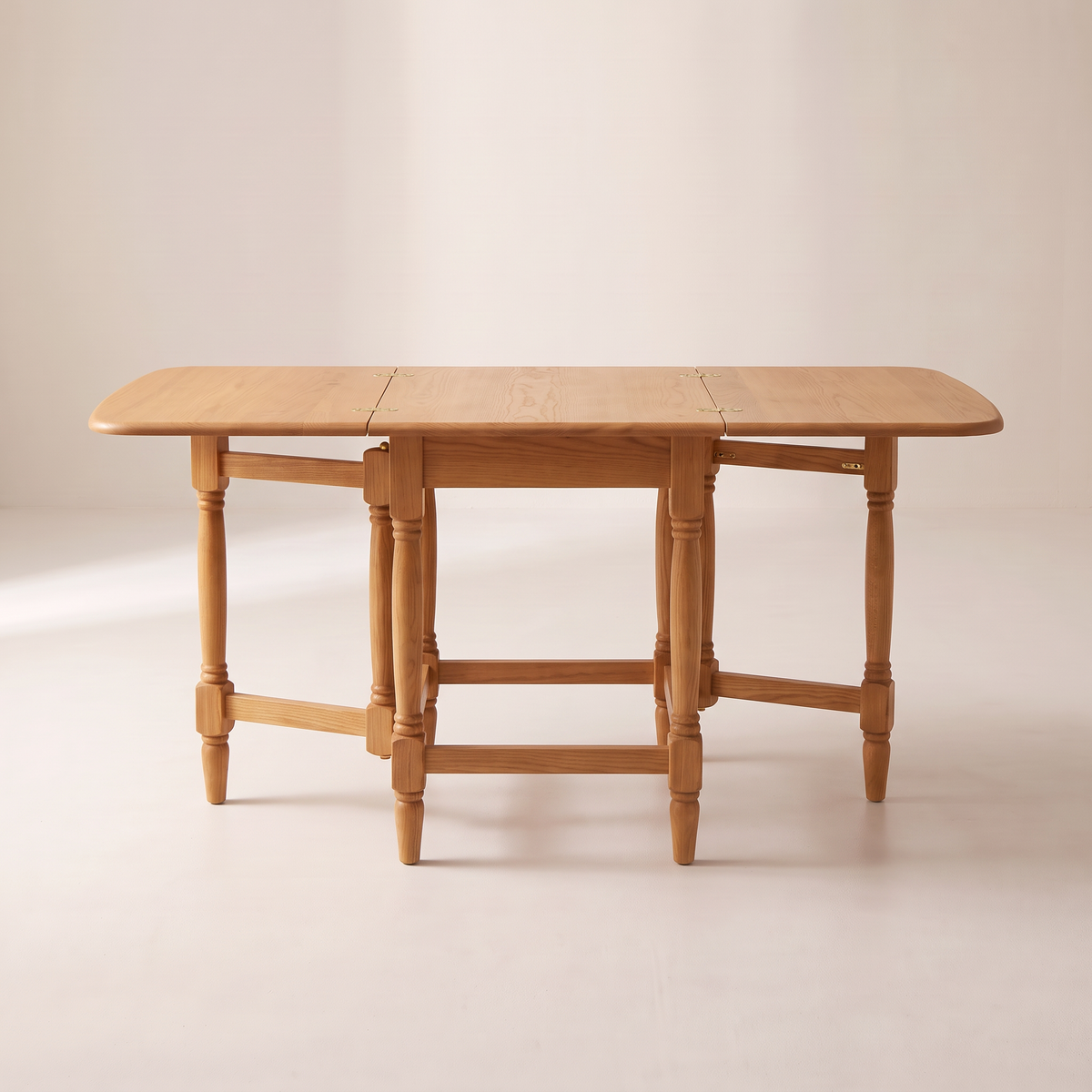 Gateleg Compact honey ash drop-leaf table fully open, straight front elevation