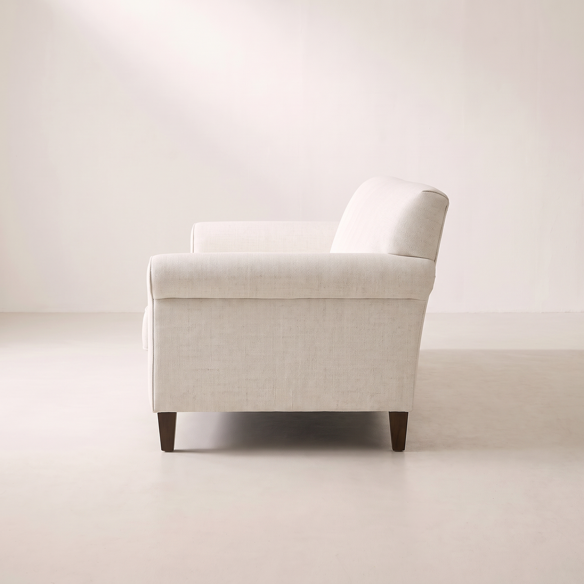Haven Ivory sofa in ivory woven upholstery with rolled arm, side profile view