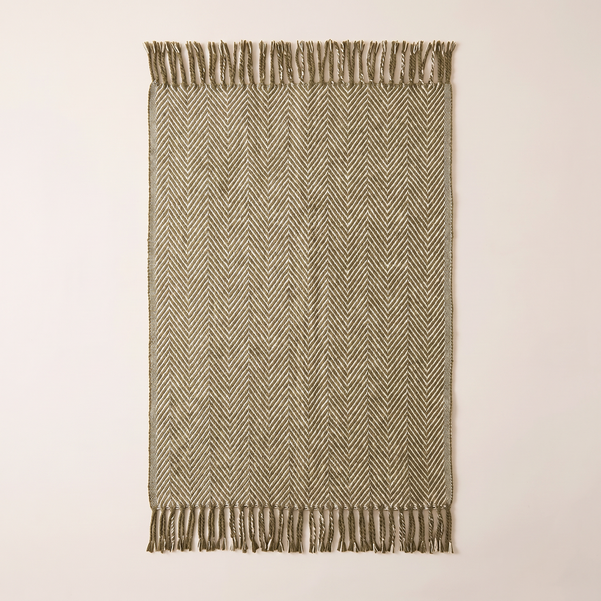 Herringbone Fringe Throw spread flat, overhead view showing the olive and cream herringbone and fringed ends